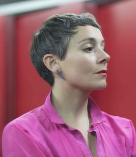 Soprano Anna Dennis gazes towards the right of the image, her head held high, a serious look on her face.