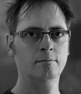 Black and white headshot of Chris Ekers.