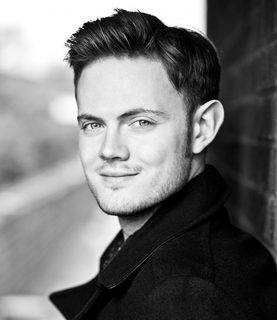 Black and white image of Nick Pritchard smiling into the camera.
