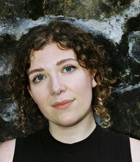 DJ Rowan McIlvride looks directly at the camera with a tilted head.