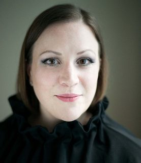 A close-up of Lucy Johnston looking directly into the camera.