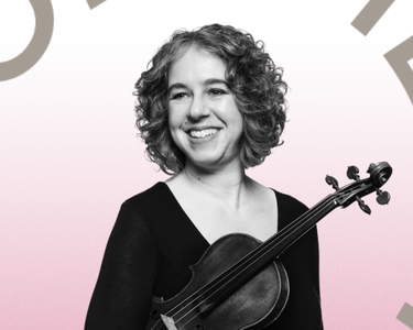 Stephanie Gonley smiles and looks out to the right, she holds her violin.