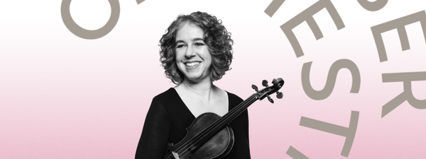 Stephanie Gonley smiles and looks out to the right, she holds her violin.