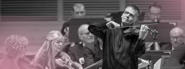 Pekka plays the violin with a smile.