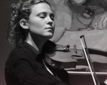 Lorenza Borrani plays the violin with an renaissance style painitng behind her.