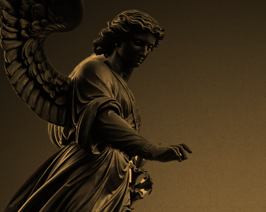 An angel statue with a golden hue.