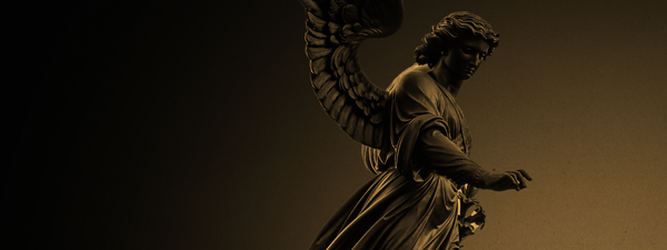 An angel statue with a golden hue.