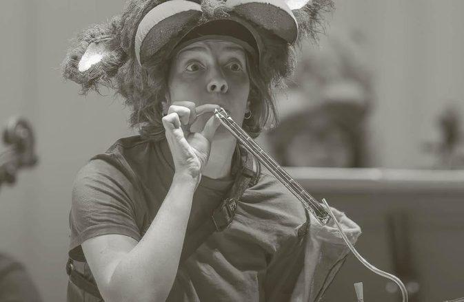 Cerys and Cebrian in costume as their Gaboon characters with their instruments performing.
