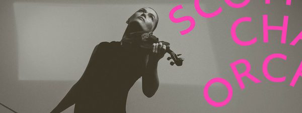 Mari Samuelson holds the violin and wears a long black dress.