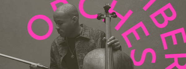 Sheku looks down and to the right. He holds his bow and cello.