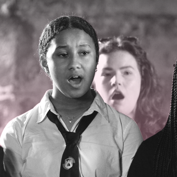 3 members of the Craigmillar youth choir sing, they wear school unirom.