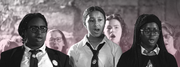 3 members of the Craigmillar youth choir sing, they wear school unirom.