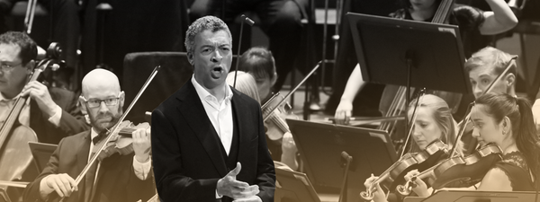 Roderick Williams sings at the Proms with the Orchestra playing behind.
