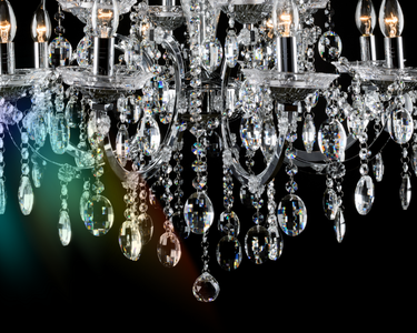 A diamond-like chandelier hangs down with a prism of colour shining from it.