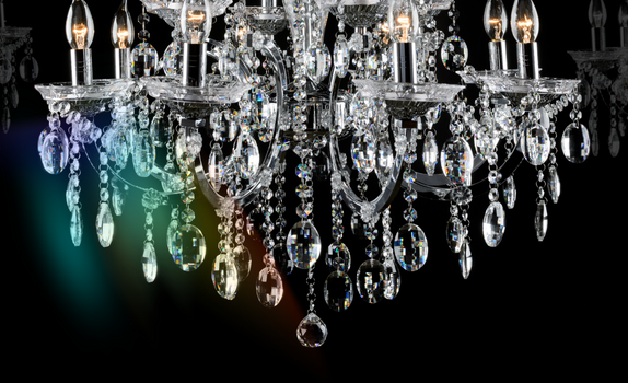A diamond-like chandelier hangs down with a prism of colour shining from it.