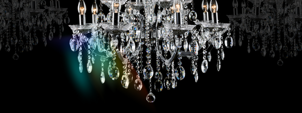 A diamond-like chandelier hangs down with a prism of colour shining from it.