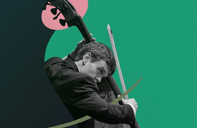 SCO Principal Double Bass Nikita Naumov playing his instrument in front of a bright green background with dark green and light pink shapes.