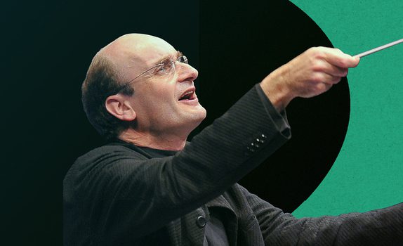 Andrew Manze, conducting with the baton raised high, against a vibrant background with bright and dark green tones.