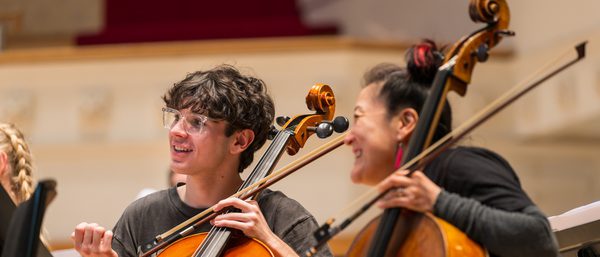 Su-a Lee laughs with a young cello player