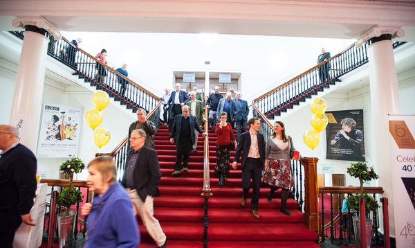 The staircase leading up to the auditorium, seen as audience members are coming down the stairs after a concert.
