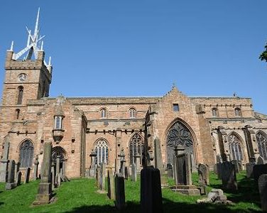 St Michael's Parish Church shown from the side on a sunny day.