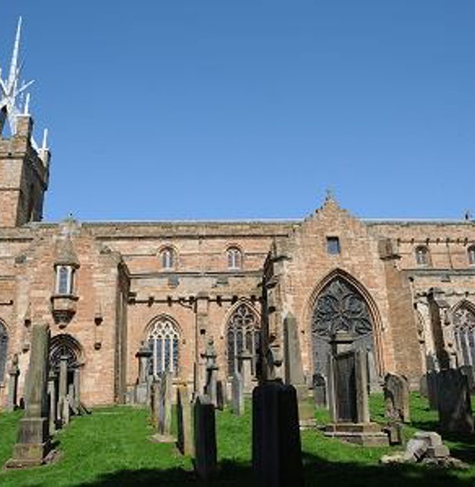 St Michael's Parish Church shown from the side on a sunny day.