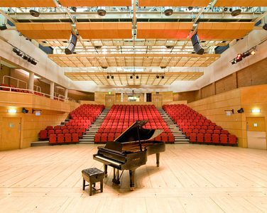 Stevenson Hall auditorium, photographed from the back of the stage on which there is a grand piano.
