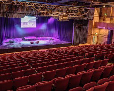 The stage of Rothes Hall in Glenrothes shot from the back of the auditorium.